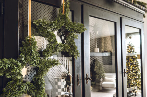 Christmas star wreaths hanging from ribbon on the cabinet