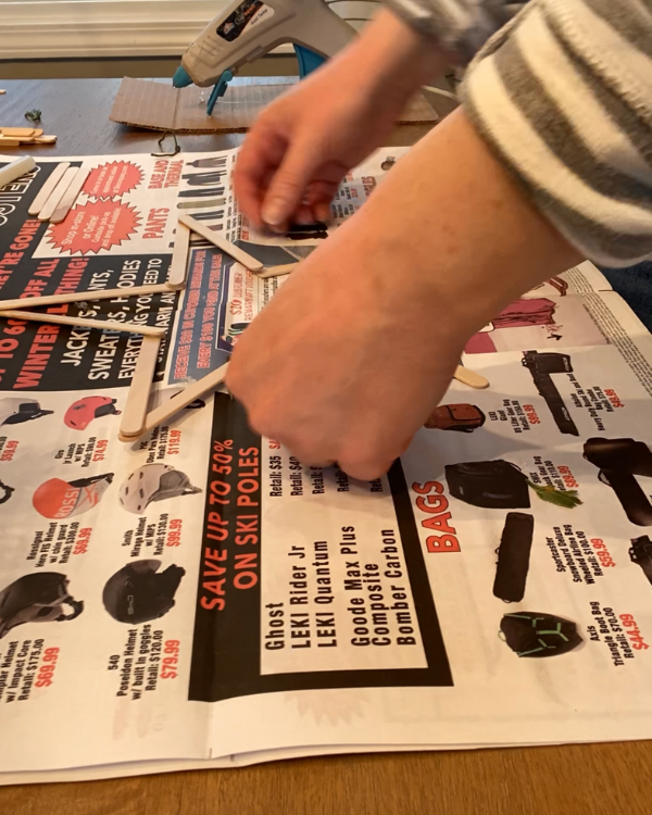 Gluing the popsicle sticks into a star.
