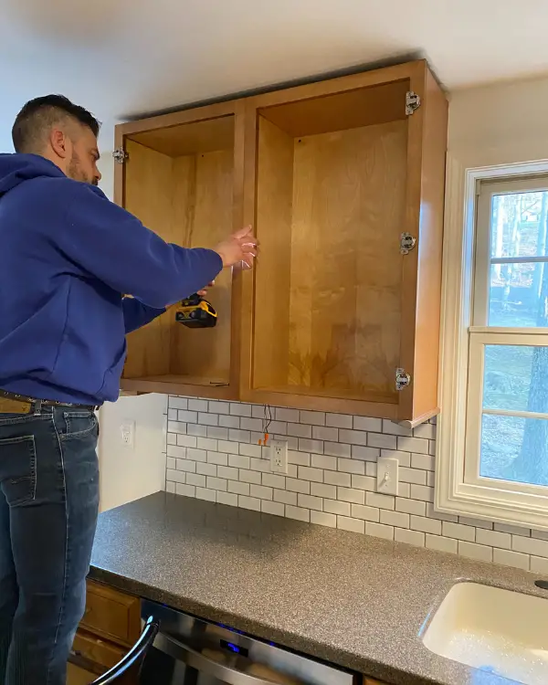 Removing the cabinet by unscrewing it.