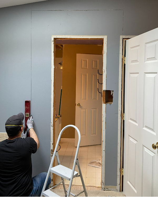 Using a level to cut around the doorway