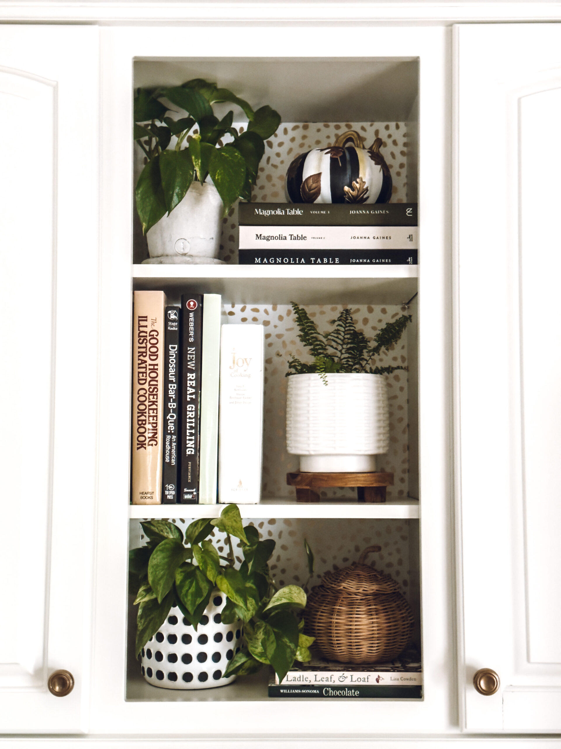Place pumpkins on the shelves in the kitchen