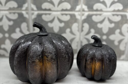 2 black glass pumpkins lit up showing a simple fall decor idea