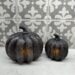 2 black glass pumpkins lit up showing a simple fall decor idea