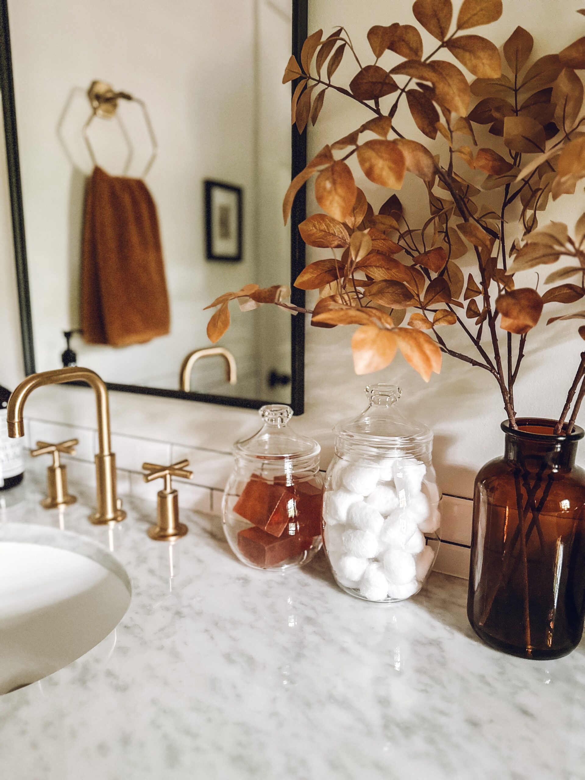fall orange soap bars in a clear canister on the bathroom counter
