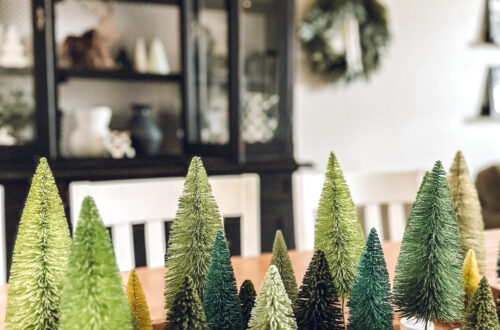 bottle brush trees in shades of green filling a long tray on the table