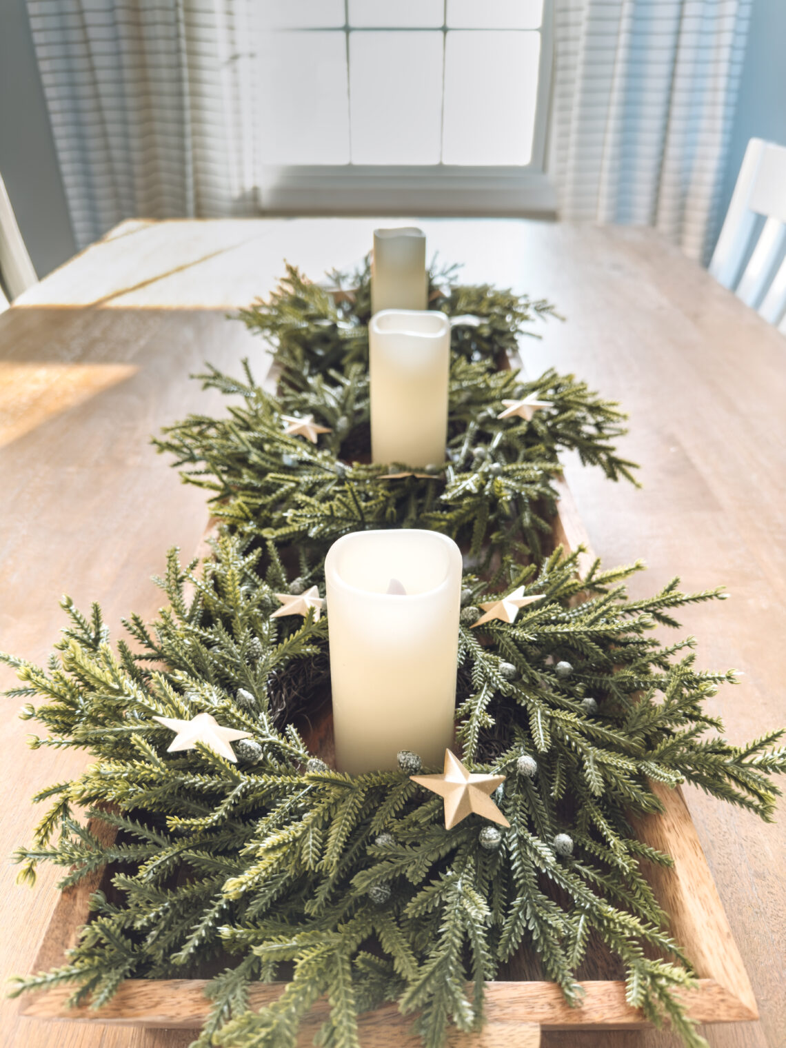 Christmas centerpiece using a large tray with mini wreaths and candles
