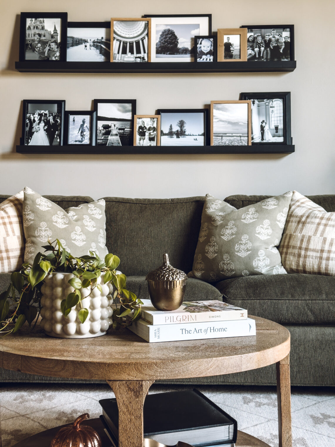 photo ledges displaying all black and white photos in only black or natural wood frames